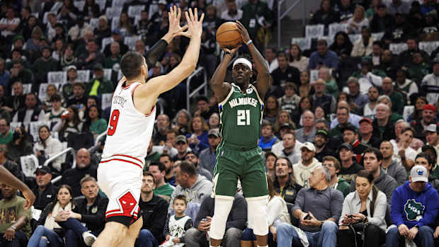 Milwaukee Bucks guard Jrue Holiday (21) shoots against Chicago Bulls center Nikola Vucevic (9)